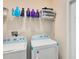 Convenient laundry room with washer, dryer, and overhead shelving at 2340 Grasmere View S Pkwy, Kissimmee, FL 34746