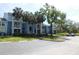 Multi-story apartment building with balconies, palm trees and well-manicured lawns, with a parking area in front at 2592 Grassy Point Dr # 106, Lake Mary, FL 32746