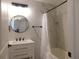 Updated bathroom with a tub, marble walls, and black accents at 2592 Grassy Point Dr # 106, Lake Mary, FL 32746