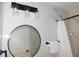 Bathroom featuring a round mirror, and modern lights against a white marble wall at 2592 Grassy Point Dr # 106, Lake Mary, FL 32746