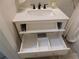 Bathroom vanity featuring sleek white cabinetry and ample drawer storage with dividers at 2592 Grassy Point Dr # 106, Lake Mary, FL 32746