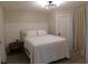 Well-lit bedroom with a queen-size bed and modern lighting fixture at 2592 Grassy Point Dr # 106, Lake Mary, FL 32746