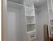 Spacious walk-in closet featuring white shelves and drawers for ample storage at 2592 Grassy Point Dr # 106, Lake Mary, FL 32746