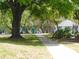 Paved pathway leading to a community playground with mature trees at 2592 Grassy Point Dr # 106, Lake Mary, FL 32746