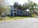 Exterior of building with palm trees, bushes, and trees on the property at 2592 Grassy Point Dr # 106, Lake Mary, FL 32746