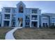 Modern condo building with light blue exterior, walkway, and grassy area at 2592 Grassy Point Dr # 106, Lake Mary, FL 32746