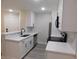 Bright kitchen featuring white cabinets, quartz countertops, stainless steel appliances, and a modern faucet at 2592 Grassy Point Dr # 106, Lake Mary, FL 32746