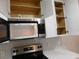 Stainless steel microwave and electric range with white cabinets in a modern kitchen at 2592 Grassy Point Dr # 106, Lake Mary, FL 32746