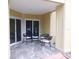 Private patio with four black chairs and tile flooring at 2592 Grassy Point Dr # 106, Lake Mary, FL 32746