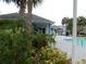 Exterior view of the community pool surrounded by lush palm trees at 2592 Grassy Point Dr # 106, Lake Mary, FL 32746