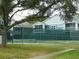 Community tennis court with shade trees at 2592 Grassy Point Dr # 106, Lake Mary, FL 32746