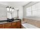 Bathroom with granite double vanity, large mirror and bathtub at 2607 E Jefferson St, Orlando, FL 32803