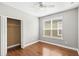 Bright bedroom with hardwood floors, a ceiling fan, and a large closet at 2607 E Jefferson St, Orlando, FL 32803