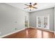 Hardwood floor bedroom with french doors, ceiling fan and bathroom access at 2607 E Jefferson St, Orlando, FL 32803