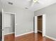 Bedroom with hardwood floors, neutral walls, and a large closet at 2607 E Jefferson St, Orlando, FL 32803