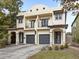 Two-story duplex with Spanish-style architecture, featuring two attached garages at 2607 E Jefferson St, Orlando, FL 32803