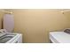 Laundry room with washer, dryer, and shelving at 2607 E Jefferson St, Orlando, FL 32803