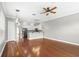 Bright living room with hardwood floors, ceiling fan, and access to kitchen at 2607 E Jefferson St, Orlando, FL 32803