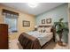 Bedroom with queen-size bed and adjacent bathroom at 2715 Manesty Ln, Kissimmee, FL 34747