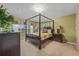 Main bedroom with canopy bed and neutral color scheme at 2715 Manesty Ln, Kissimmee, FL 34747