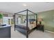 Main bedroom with canopy bed and neutral color scheme at 2715 Manesty Ln, Kissimmee, FL 34747