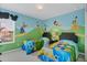 Two twin beds in a themed bedroom with Disney character wall decor at 2715 Manesty Ln, Kissimmee, FL 34747