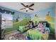 Two twin beds in a themed bedroom with Disney character wall decor at 2715 Manesty Ln, Kissimmee, FL 34747