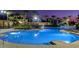 Night view of resort-style pool with water features and lighting at 2715 Manesty Ln, Kissimmee, FL 34747