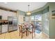 Bright dining area with glass table and chairs near the kitchen and pool at 2715 Manesty Ln, Kissimmee, FL 34747