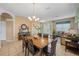 Dining area with a wooden table and chairs, adjacent to living room at 2715 Manesty Ln, Kissimmee, FL 34747