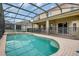 Large, screened pool with spa and patio access at 2715 Manesty Ln, Kissimmee, FL 34747