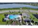 Aerial view of community pool and clubhouse near a lake at 2777 Flushing Dr, Apopka, FL 32703