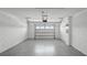 Attached garage with white block walls and epoxy floor at 2777 Flushing Dr, Apopka, FL 32703