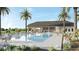 Community pool and clubhouse with palm trees and landscaping at 2777 Flushing Dr, Apopka, FL 32703