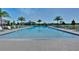 Community pool with lounge chairs and palm trees at 2781 Flushing Dr, Apopka, FL 32703