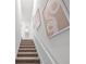 Modern staircase with neutral carpeting and wall art at 2781 Flushing Dr, Apopka, FL 32703