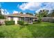 Large backyard with a screened porch and well-manicured lawn at 2842 Eastern Pkwy, Winter Park, FL 32789