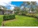 Spacious backyard with a neatly trimmed lawn and hedges at 2842 Eastern Pkwy, Winter Park, FL 32789