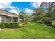 Landscaped backyard with lush greenery and a screened patio at 2842 Eastern Pkwy, Winter Park, FL 32789