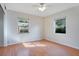 Spacious bedroom with wood floors and dual windows at 2842 Eastern Pkwy, Winter Park, FL 32789