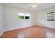 Spacious bedroom with wood floors and large window at 2842 Eastern Pkwy, Winter Park, FL 32789