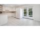 Kitchen with white cabinets, tile floors, and backyard access at 2842 Eastern Pkwy, Winter Park, FL 32789