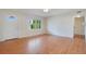 Spacious living room with hardwood floors and an adjacent hallway at 2842 Eastern Pkwy, Winter Park, FL 32789