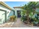 Brick walkway to front door, palm trees and well manicured landscaping at 300 Sorrento Rd, Poinciana, FL 34759