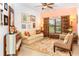 Living room with beige couch and floral patterned rug at 300 Sorrento Rd, Poinciana, FL 34759