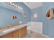 Bathroom with light blue walls, granite countertop, and a bathtub at 306 Kettering Rd, Davenport, FL 33897