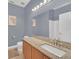 Bathroom with granite countertop and gray walls at 306 Kettering Rd, Davenport, FL 33897