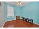 Small bedroom with light blue walls and wood-look floors at 306 Kettering Rd, Davenport, FL 33897