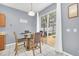 Bright dining area with glass table and view to backyard at 306 Kettering Rd, Davenport, FL 33897