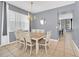 Elegant dining room with gray walls and a rustic wooden table, seating six at 306 Kettering Rd, Davenport, FL 33897